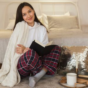 Home full shot beautiful woman sitting rug with book